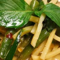 Green Curry · Fresh green chili paste with coconut milk, bamboo shoots, eggplant, bell peppers and basil.