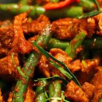Pad Prik Khing · Spicy. Sautéed with chili paste, green beans, red bell peppers, and kaffir lime leaves.