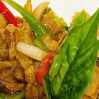 Pad Kee Mao (Drunken Noodles) · Stir-fried flat noodles with broccoli, onions, bell peppers, egg, and basil leaves.