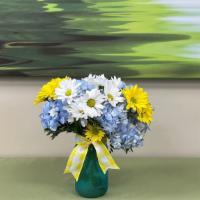 Sunny Sentiments · Blue hydrangea, caspia, white and yellow daisies arranged in a mason style container will br...