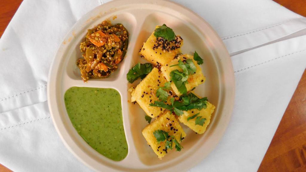 Khaman Dhokla  · savory steamed cake made from gram flour, served with carrot chili and chutney