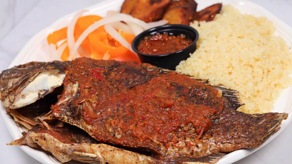 Attieke Fried Fish & Plantain · Couscous cooked to fluffy perfection and served with fried plantain, a whole seasoned fried fish, and a blend of vegetables.
