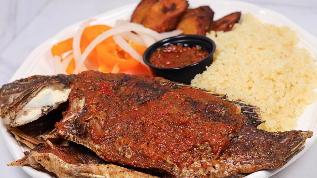Attieke Fried Fish & Plantain · Couscous cooked to fluffy perfection and served with fried plantain, a whole seasoned fried fish, and a blend of vegetables.