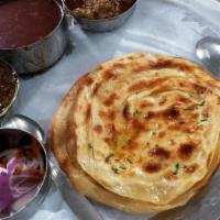 Aloo Paratha · Dough stuffed with a mixture of mashed potato and spices, which is rolled out and cooked on ...