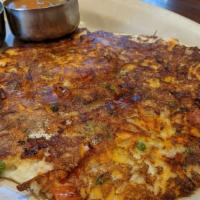 Plain Uthappam · Indian style pancake, lentil, and rice pancake. Served with sambar a traditional soup with l...