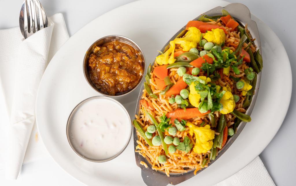 Vegetable Biryani · Basmati rice cooked with garden fresh vegetables. Basmati rice specialties served with raita (yogurt with cucumber, onion, tomato, and mustard seeds) and spicy house pickle.