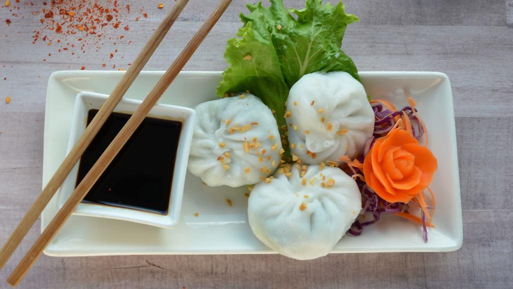 Chive Dumpling (3 Pcs) · Flour dumpling with chives served deep-fried or steamed, served with sauce on the side.