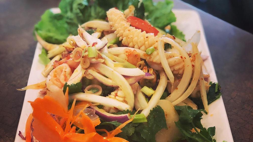 Yum Talay · Shrimp, squid, mussels, and scallops served with lettuce, green and white onions, lemon grass, kaffir leaves, and cilantro in a spicy lime dressing.