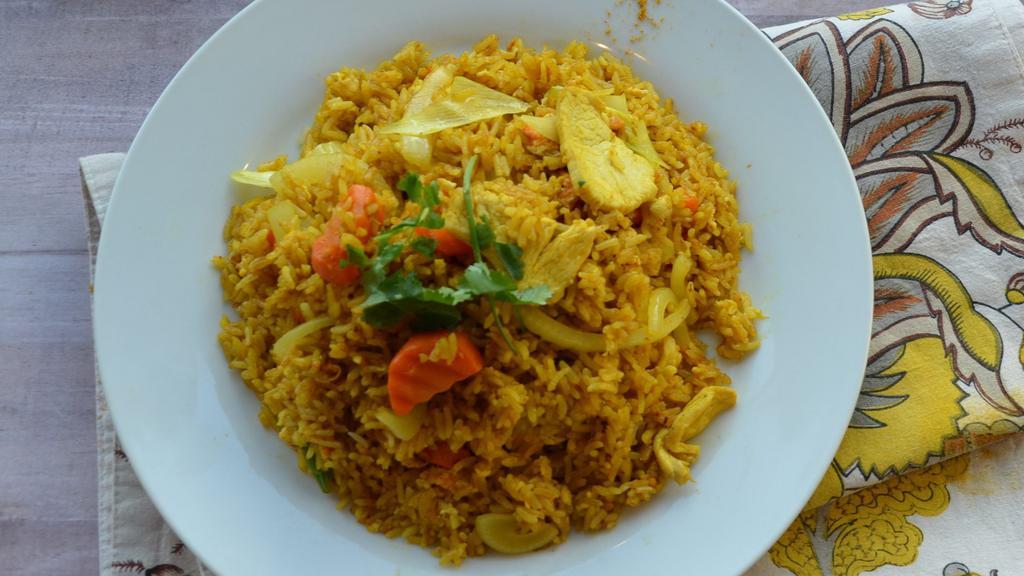Curry Fried Rice · Fried rice with yellow curry powder, egg, onion, carrot, and choice of meat.