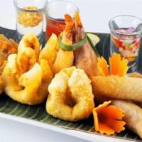 Combination Platter · A combination of four spring rolls, four golden shrimp rolls, four curry puff and four crab ...