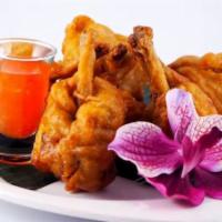 Golden Wings (6 Pieces) · Deep fried seasoned chicken wings with a mild touch of spiciness, served with sweet chili sa...