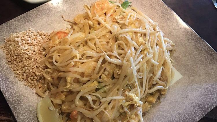 Pad Thai Curry · Sautéed rice noodles with egg, green onions, bean sprouts, tamarind juice stir fry with red curry with coconut milk, served with crushed peanut and lemon.