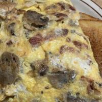House Omelette · Hash browns, ham, mushrooms, green peppers, onions, topped with cheddar cheese, two eggs any...