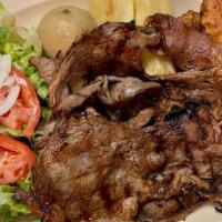 Carne Asada · Char-broiled carne asada steak. Served with potato, cassava, plantain, and salad. This steak...