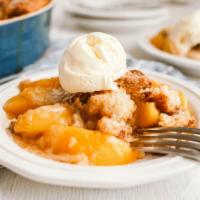 Peach Cobbler · Delicious baked dessert made with sweet peach filling topped on a buttery crust.