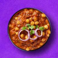 Spiced Garbanzo Curry · Garbanzo beans cooked over a slow fire with a blend of spices and fresh tomatoes, onions, gi...