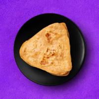 Plain Wheat Paratha · A whole-wheat layered flatbread baked on a pan. A perfect accompaniment to our entrees.