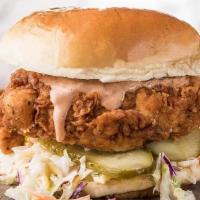 The Classic · Two Crispy Chicken Tenders, Slaw, Pickles, Served on a Brioche Bun, Served With Fries