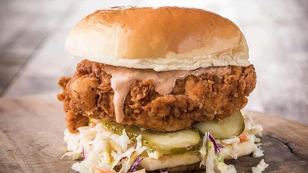 The Classic · Two Crispy Chicken Tenders, Slaw, Pickles, Served on a Brioche Bun, Served With Fries