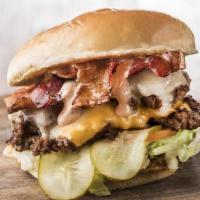 Super Herd Burger · American and Swiss Cheese, Lettuce, Tomato, Pickles, Bacon, Fancy Sauce, Served With Fries