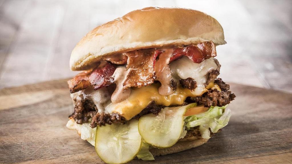 Super Herd Burger · American and Swiss Cheese, Lettuce, Tomato, Pickles, Bacon, Fancy Sauce, Served With Fries