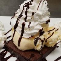 Fudge Brownie A La Mode · Decadent chocolate brownie served warm and topped with vanilla ice cream, Hershey's Chocolat...