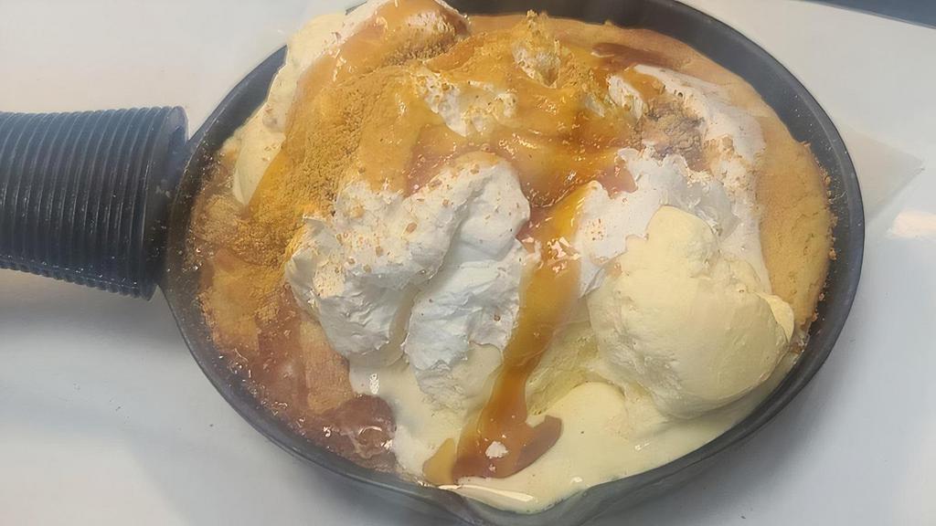 Caramel Sugar Cookie · Homemade sugar cookie baked to a warm delight, then topped with vanilla ice cream, whipped cream and drizzle of caramel.