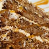 Towering Carrot Cake · Four big layers of moist carrot cake, iced and layered with a cream cheese icing. Finihsed w...