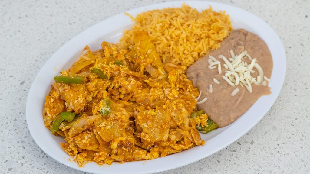 Chilaquiles · Fried corn tortillas smothered with salsa, topped with cheese, onions.