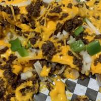 Macho Nacho · Tortilla chips topped with Angus ground beef, spicy cheese sauce, onions, tomatoes, and jala...