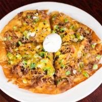 Mexican Pizza  · A giant crispy tortilla topped with ground beef or chicken, beans, cheese, green onions, tom...