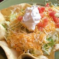Taco Salad · A giant crispy tortilla shell filled with ground beef or shredded chicken, beans, lettuce, c...