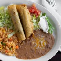 Flautas Dinner · 2 fried corn tortillas filled with shredded beef or chicken and a side of guacamole and sour...