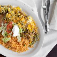 Nopalitos · Strips of cactus with your choice of shredded beef or chicken, cooked with eggs, covered wit...