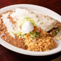 Burrito Deluxe · Big flour tortilla filled with grilled steak or chicken, shrimp, crab and chorizo, onions an...