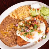 Silpancho · Milanesa de Carne o Pollo topped with two fried eggs and pico de gallo on top of Mexican ric...