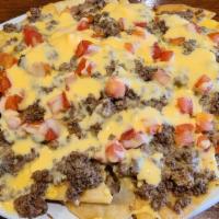Nachos Supreme · Corn or fresh fried flour tortilla chips topped with seasoned beef, beans, cheese, and tomat...
