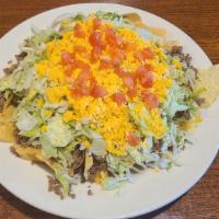 Taco Salad Chip Style · Crisp lettuce, your choice of seasoned beef or chicken, tomatoes and cheese on a bed of tort...