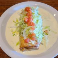 Chicken Changa · Chicken chimi with white queso, topped with lettuce, tomato, sour cream.