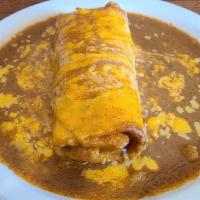 Beef Chimichanga · Shredded beef, green chilies, onions & cheese rolled in a flour tortilla & fried. Topped wit...