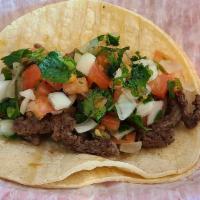 Street Taco · Seasoned steak served on a soft corn tortilla, topped with pico.