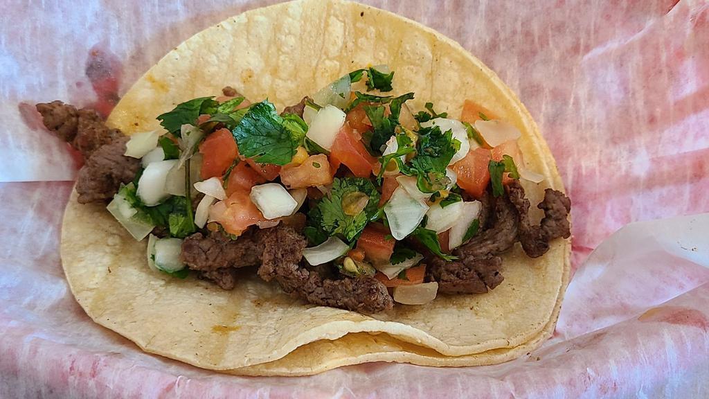 Street Taco · Seasoned steak served on a soft corn tortilla, topped with pico.