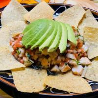 Ceviche De Camaron · Shrimp marinated in lime juice with onions, cilantro, tomato and avocados. Served with chips.
