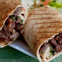 Beef Shawarma Sandwich · Shredded beef marinated and grilled, rolled with tomatoes, onions, parsley, pickles and sauce.