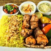 Shish Chicken Tawook · Two skewers of boneless tender pieces of chicken breast marinated in our own in-house marina...