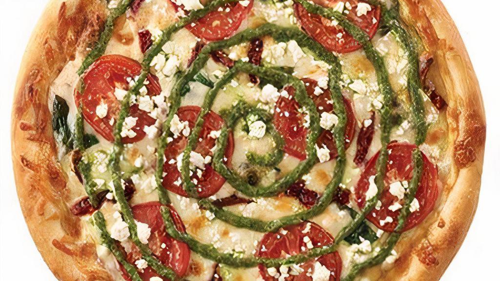 Roma Pesto Pizza · Sun dried tomato, spinach, tomato, and feta cheese, topped with a swirl of pesto (nut free). Vegetarian.