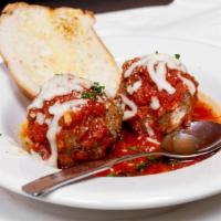 Meatballs App · Two homemade meatballs with marinara sauce and cheese.