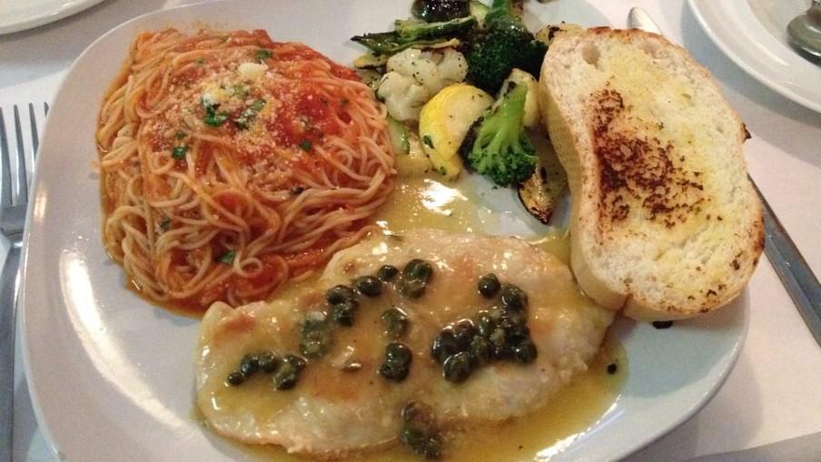 Chicken Piccata · White wine lemon butter sauce, capers, served with pasta and mixed vegetables.