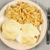 Eggs Benedict · Two poached eggs and Canadian bacon on top of an English muffin. Topped with hollandaise sau...