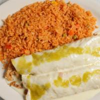 Burritos El Cancún · Two flour tortillas filled with beef tips and refried beans. Topped with melted cheese, sour...